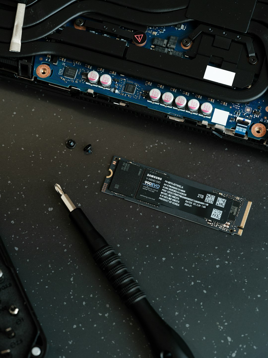 portfolio-01 a-close-up-of-a-motherboard-and-a-pen-on-a-table-bomkfqkphro