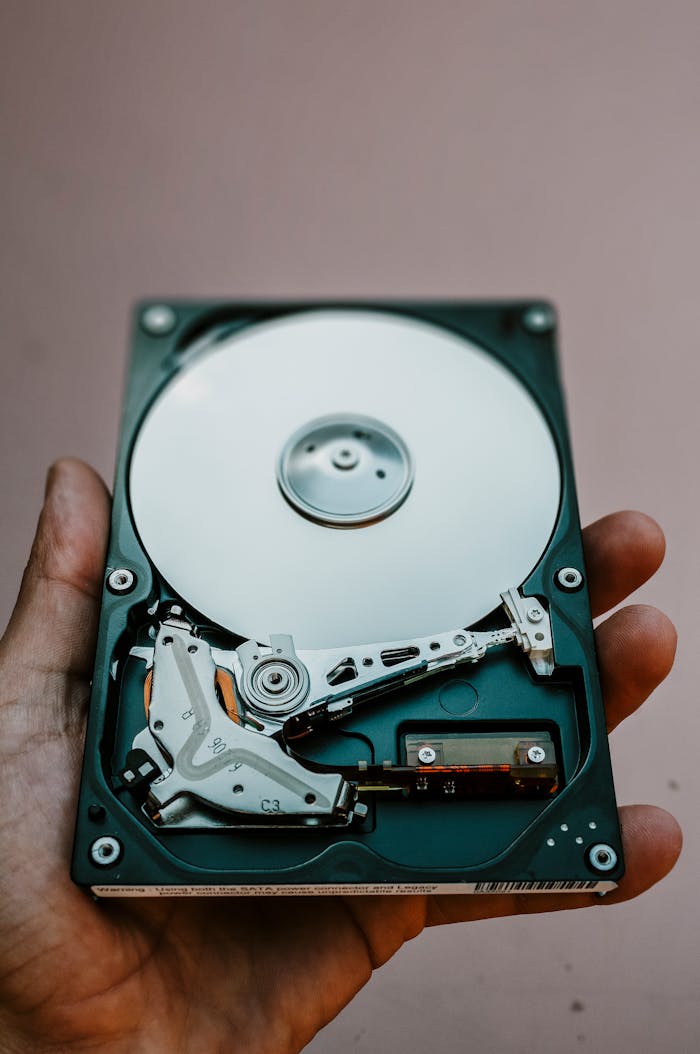 creative-approach-img Close-up view of an open hard drive held in a hand, illustrating data storage technology.